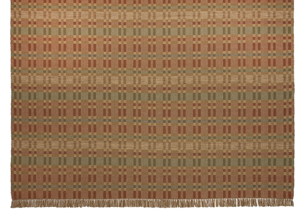 Geometric Checkerboard #90-M is a flat woven check design with various size squares that form an interesting pattern. This colorway works well in a more country or rustic home and features rust, tan, green and blue. This versatile design is shown here in a large room size area rug with fringe.