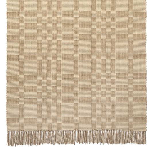 Geometric Checkerboard #34-L is a flat woven check design with various size squares that form an interesting pattern. This colorway works well in any home, but has a more modern feeling. Neutrals coordinate well with all styles and it is plain without being boring. This versatile design features khaki and natural beige and is shown here as a 27 inch wide runner with fringed ends.