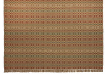 Geometric Checkerboard #90-M is a flat woven check design with various size squares that form an interesting pattern. This colorway works well in a more country or rustic home and features rust, tan, green and blue. This versatile design is shown here in a large room size area rug with fringe.