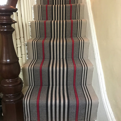 Hamilton #201-R is a bold flat woven rug design with black and red stripe on beige background shown here installed on stairs. 