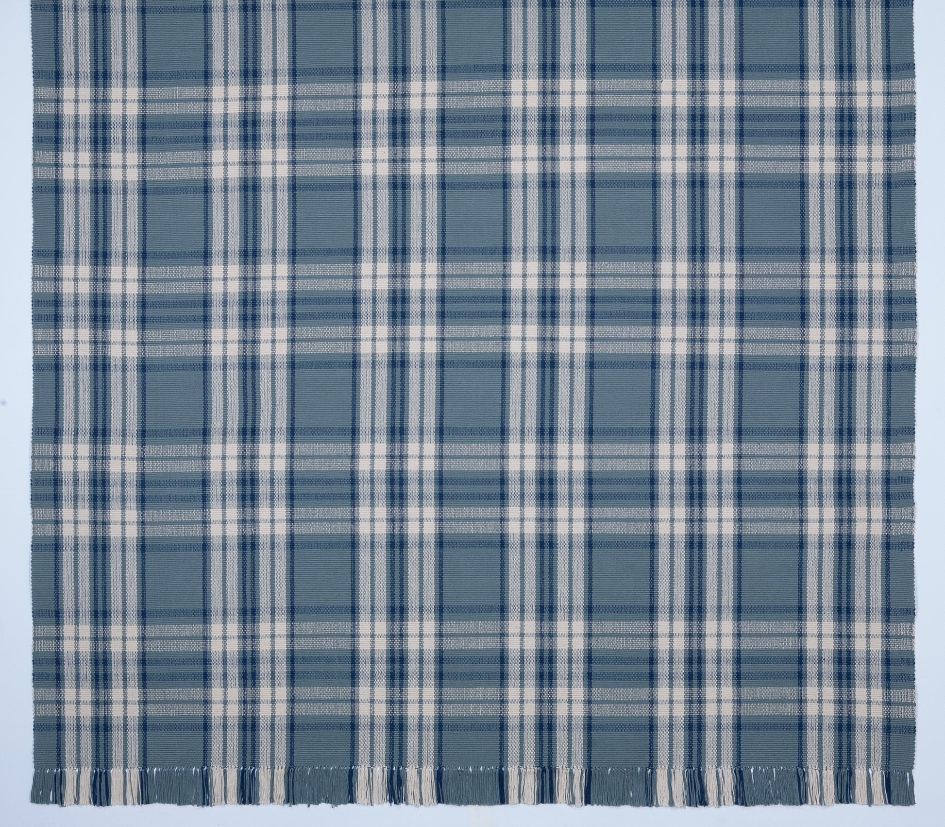 Kentwood #556 is a traditional blue plaid design featuring a medium blue background with cream and navy stripes. Beautiful in a beach or coastal home, or add a bit of country to your kitchen with a runner.